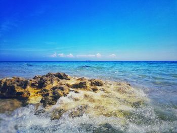 Scenic view of sea against blue sky