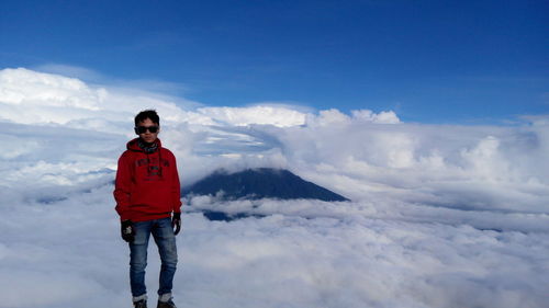 Full length of young man standing against sky