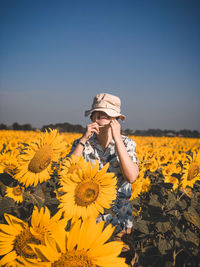 Low angle view of sunflower on field against clear sky