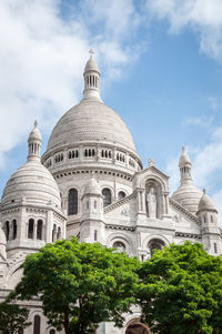 The basilica of the sacred heart in montmartre under a beautiful blue summer sky in paris france
