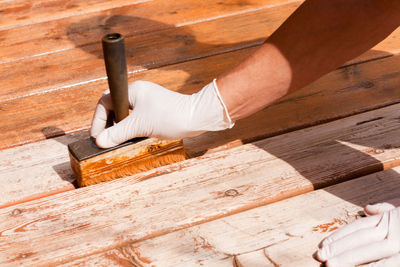 High angle view of man working on wooden plank