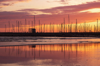 Silhouette sailboat on sea against sky during sunset