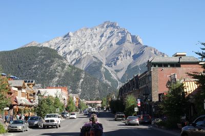 Cars on road against mountain range