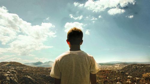 Man standing on mountain against sky