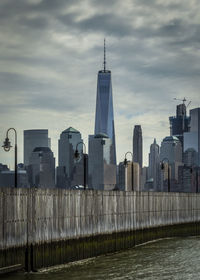 View of cityscape against cloudy sky