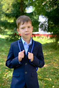 Portrait of boy standing outdoors