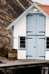 Old wooden house in front of building