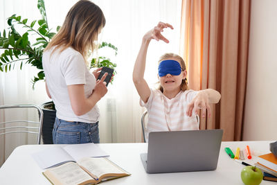 Mother helping daughter with homework