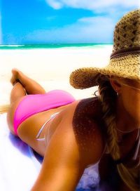 Low section of woman standing on sandy beach