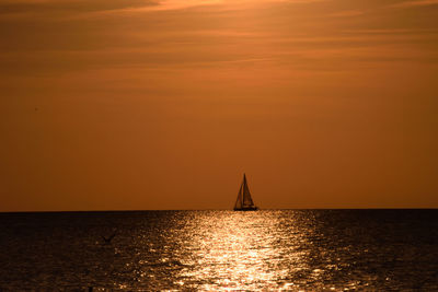 View of sailboat in sea during sunset