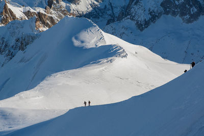 Tourists on snow covered landscape