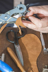 Close-up of shoemaker making sandal at workshop