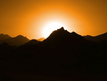 Scenic view of silhouette mountains against sky during sunset