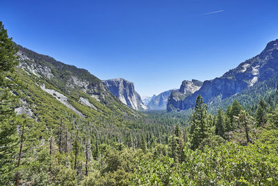 Scenic view of mountains against blue sky