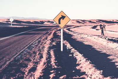 Road sign against clear sky