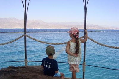 Rear view of father and son at sea