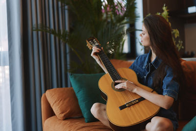 Young woman playing guitar