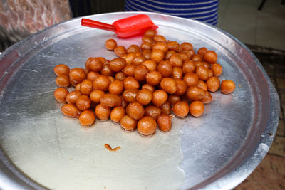 High angle view of gulab jamun on big plate for sale at market