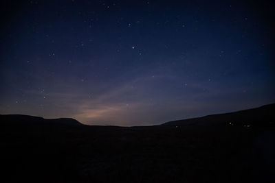 Scenic view of silhouette mountain against sky at night