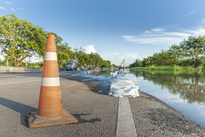 Road by lake against sky