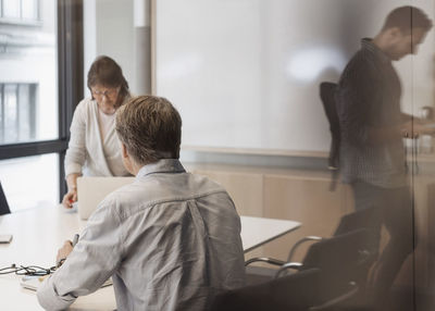 Business people working in board room
