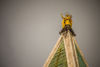 Low angle view of statue against building