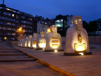 Illuminated city against sky at night