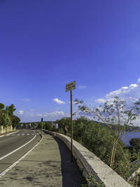 Road sign against sky