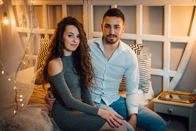 Young couple sitting at home