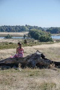 Woman sitting on field