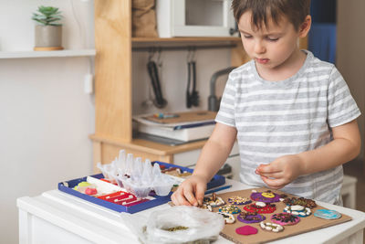 Portrait of cute girl painting at home