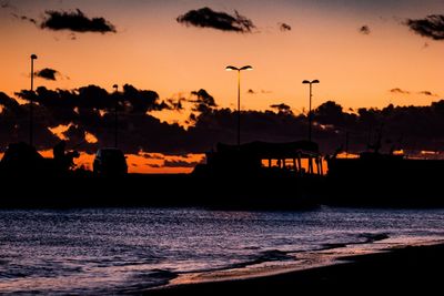 Scenic view of sea against orange sky