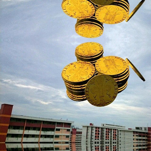 architecture, sky, low angle view, built structure, building exterior, cloud - sky, multi colored, outdoors, day, cloud, yellow, no people, cloudy, reflection, nature, protection, city, pattern, hanging, ferris wheel