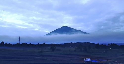 Scenic view of landscape against cloudy sky