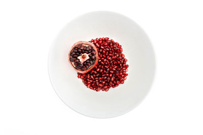High angle view of raspberries in bowl against white background