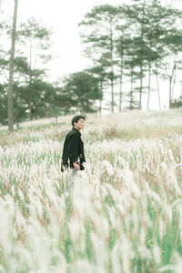Portrait of man standing in the middle of white reeds
