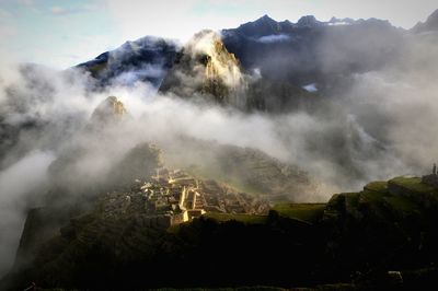 Scenic view of mountains against cloudy sky