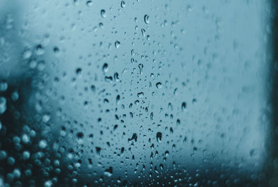 Full frame shot of raindrops on glass window