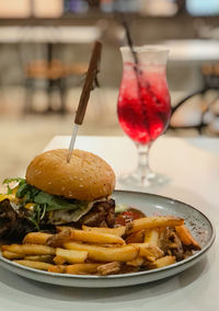 Close-up of grill chicken burger in plate on table