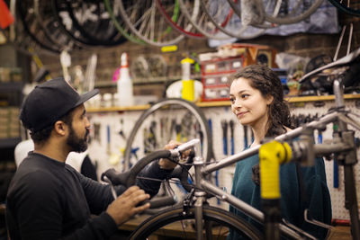 Workers talking while working in workshop