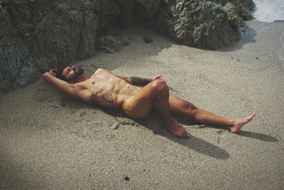 High angle view of person lying on sand
