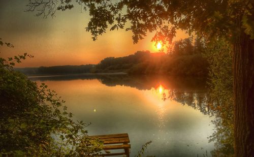 Scenic view of lake against sky during sunset