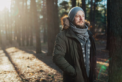 Man standing in forest during winter