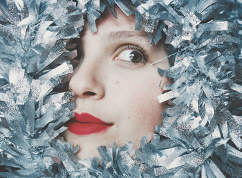 Close-up portrait of young woman in snow