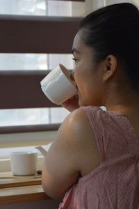 Young woman drinking coffee cup