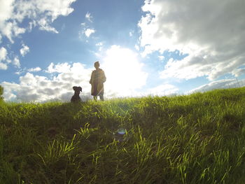 View of grassy field against cloudy sky
