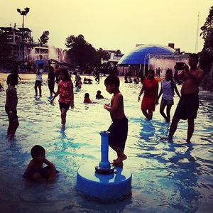 People on water against clear sky