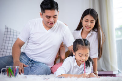 High angle view of father and daughter sitting at home