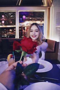 Portrait of a smiling young woman holding food