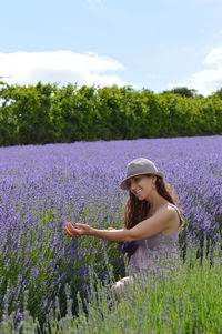 Woman standing on field with purple flowers